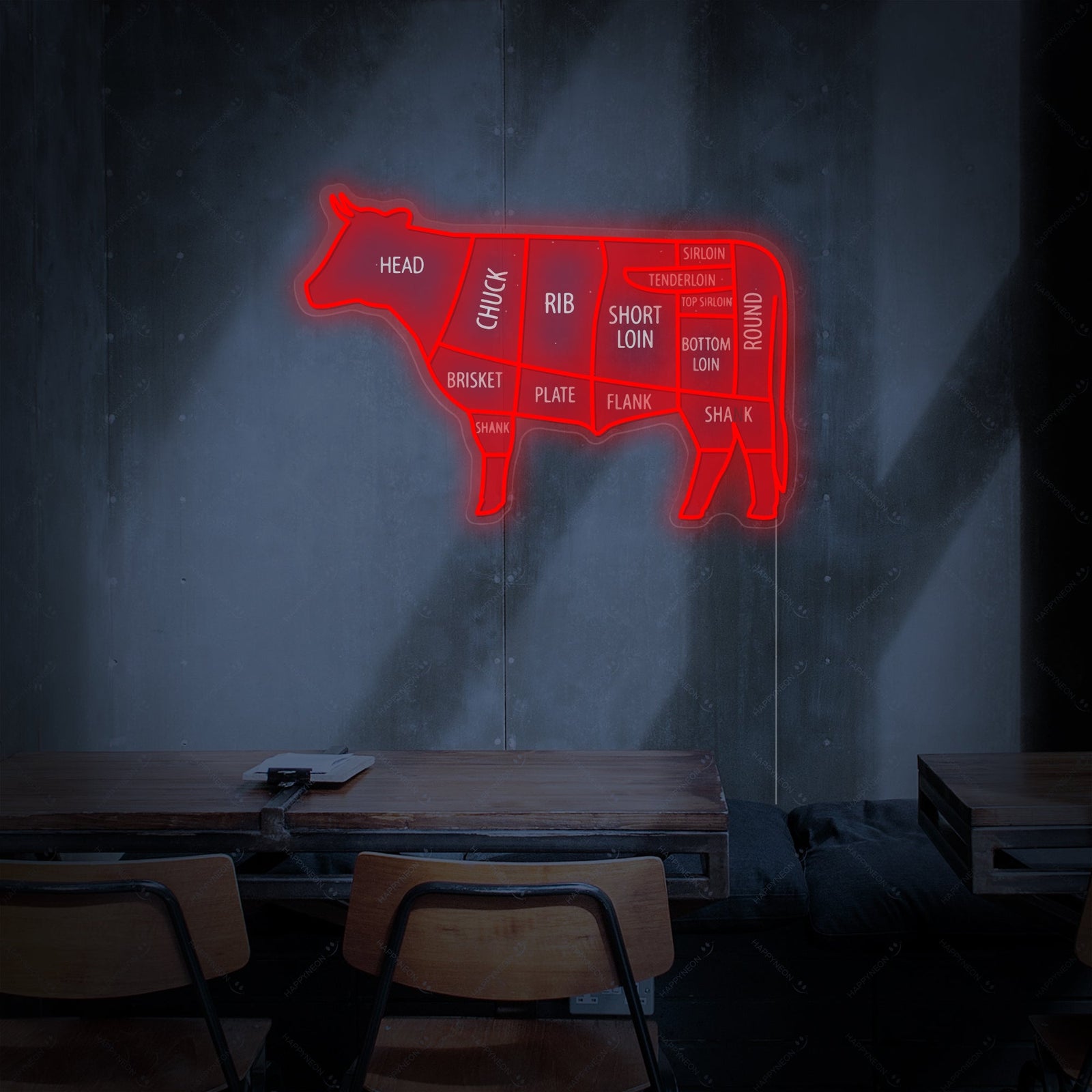 A glowing red and white neon sign in the shape of a cow with sections labeled for different beef cuts, including flank, loin, and brisket.