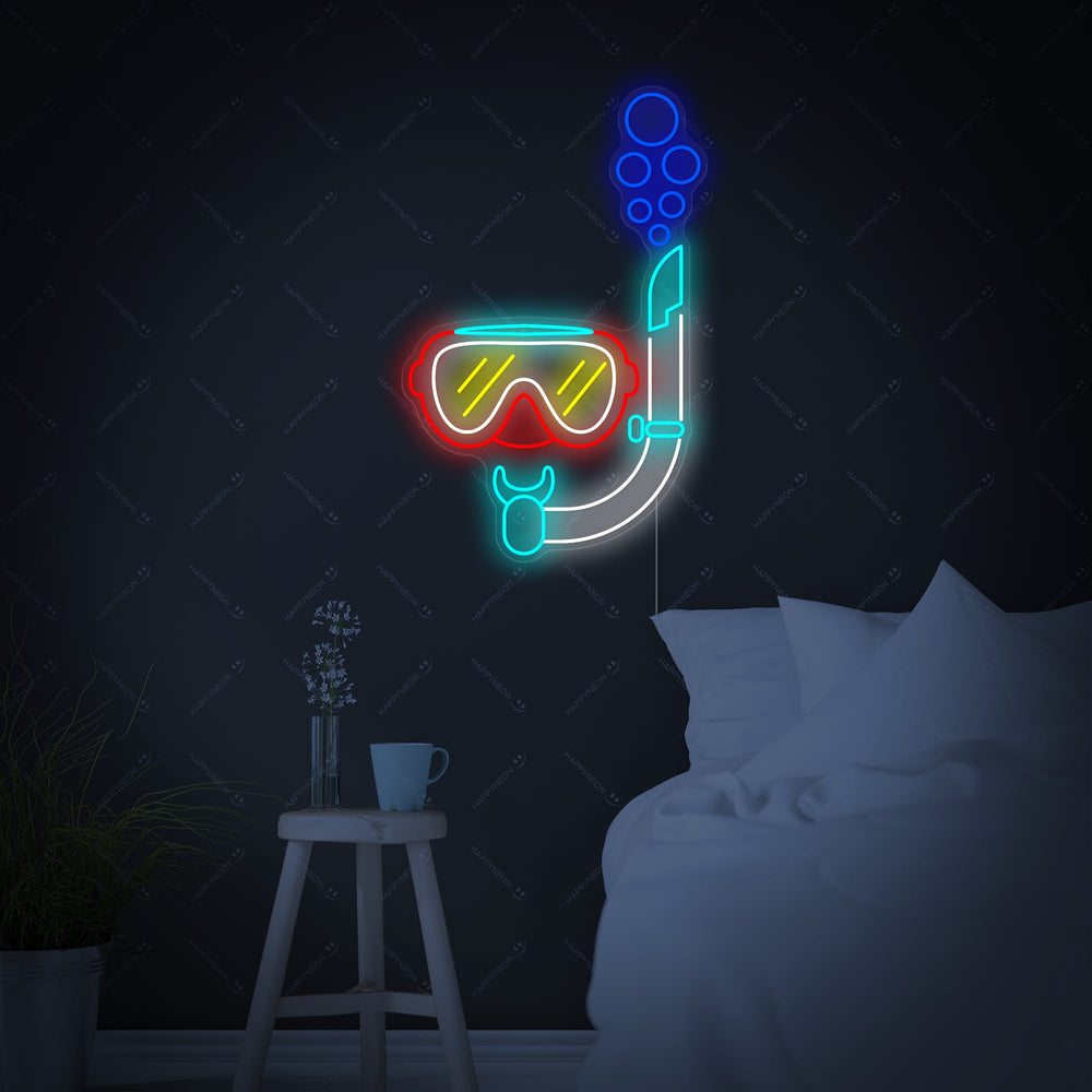 A close-up view of the illuminated 'Diving Snorkel Mask' neon sign mounted on a dark wall.