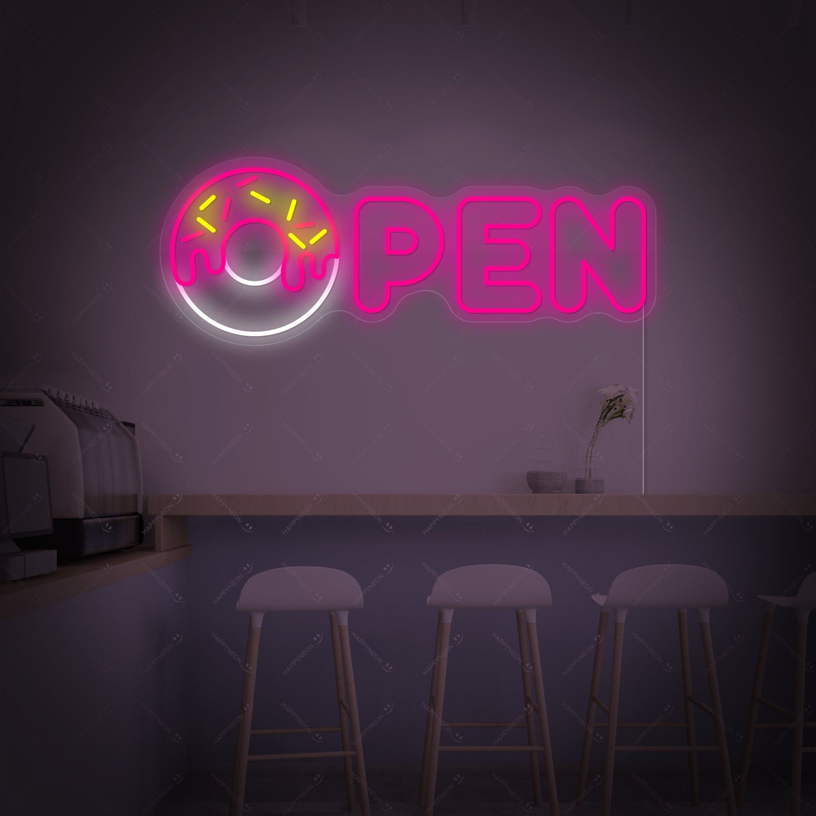 Close-up photograph showing the realistic, colorful neon tubing of the 'Donut Open' sign mounted on a textured wall above a wooden counter in a cafe environment.