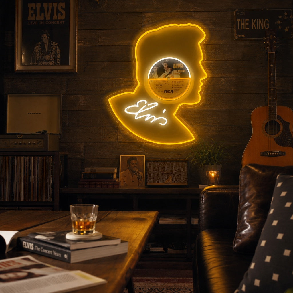 Elvis neon sign displayed above a vinyl record player and records in a cozy room, showing a glowing record graphic and the word Elvis in red script.