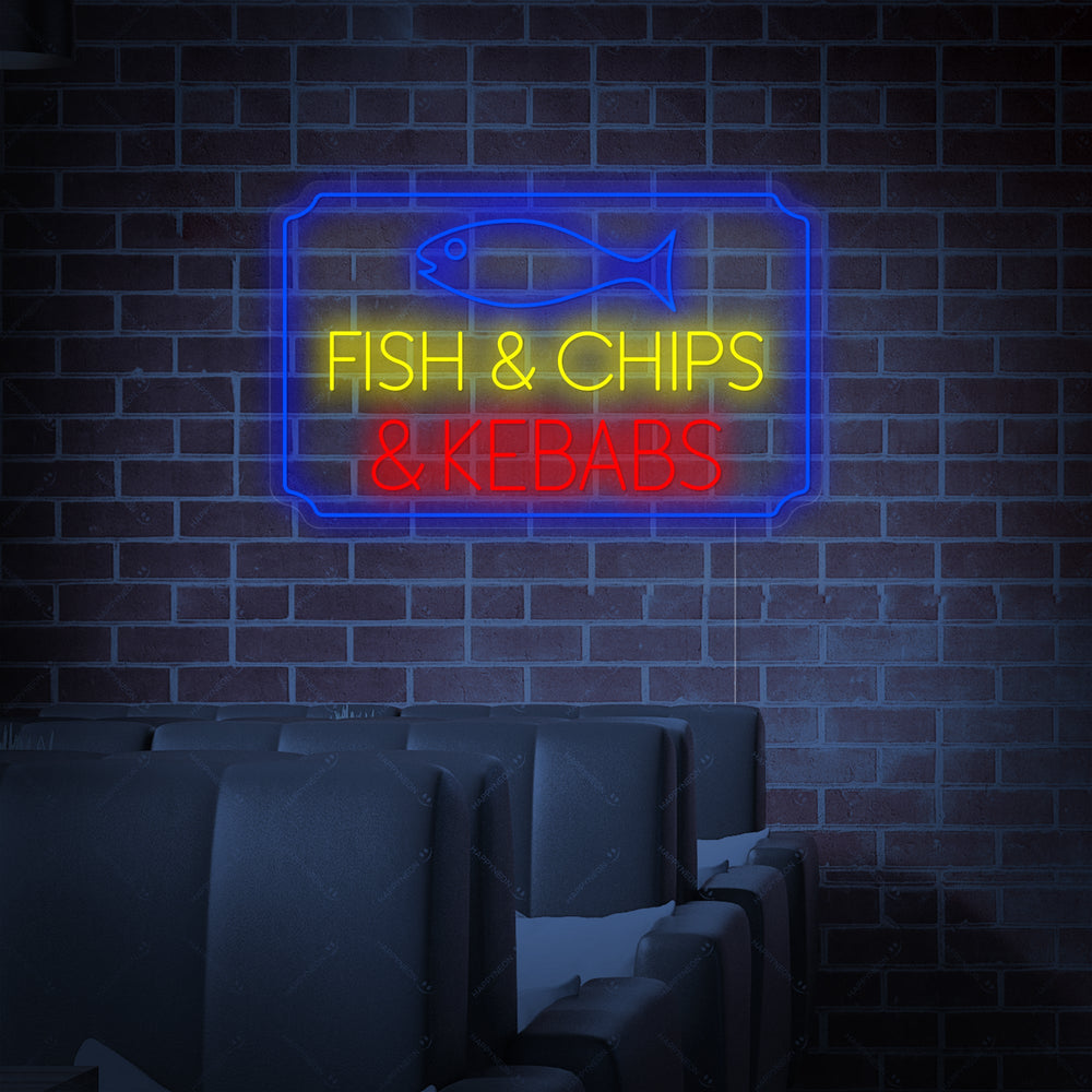 A glowing 'Fish Chips Kebabs' neon sign with text in different colors on an acrylic backing.