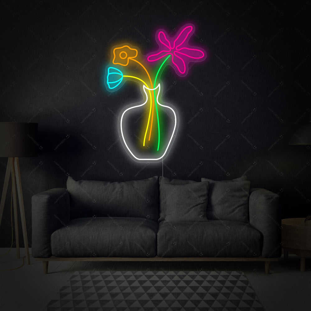 A illuminated glowing pink flower neon wall art sign against a clean white textured background.
