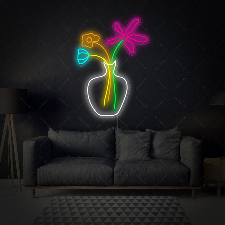 A illuminated glowing pink flower neon wall art sign against a clean white textured background.