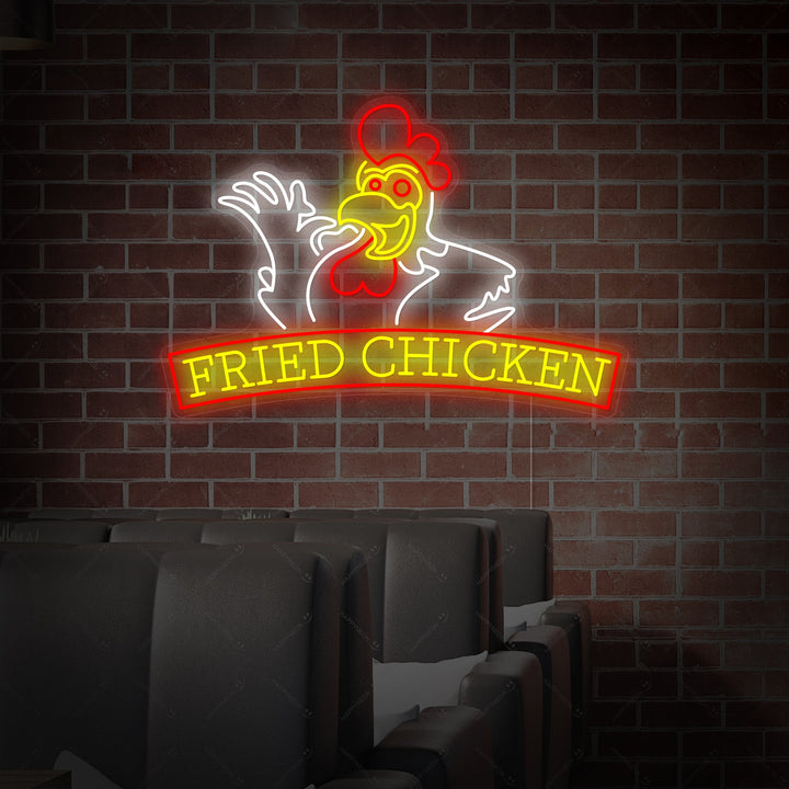 A glowing 'FRIED CHICKEN' neon sign with bold, rounded letters is mounted centrally on a rustic red brick wall, casting a red glow on the texture.