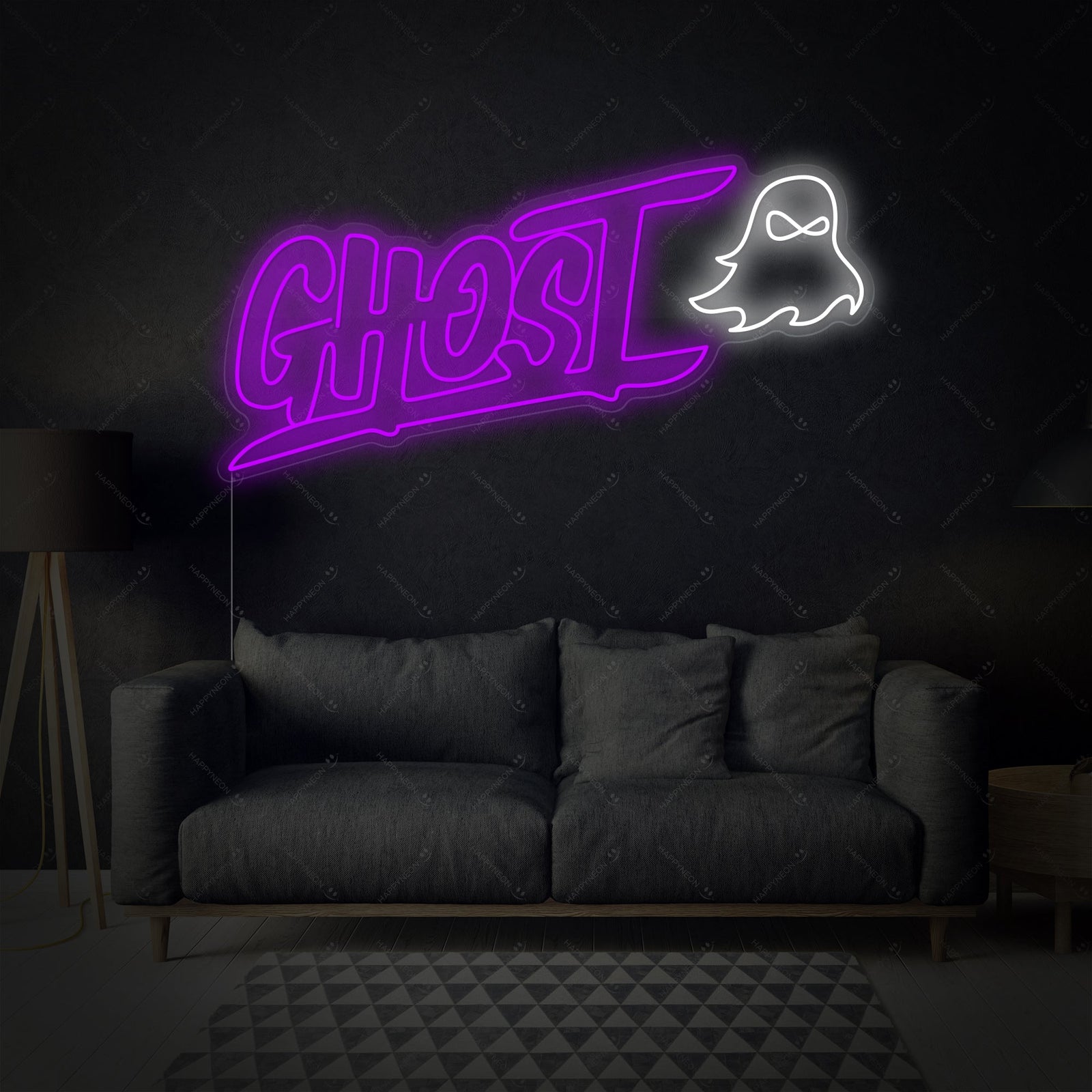 A close-up photograph of the glowing Ghost Neon Sign with its distinct outline and internal structure, set against an indoor wall background.