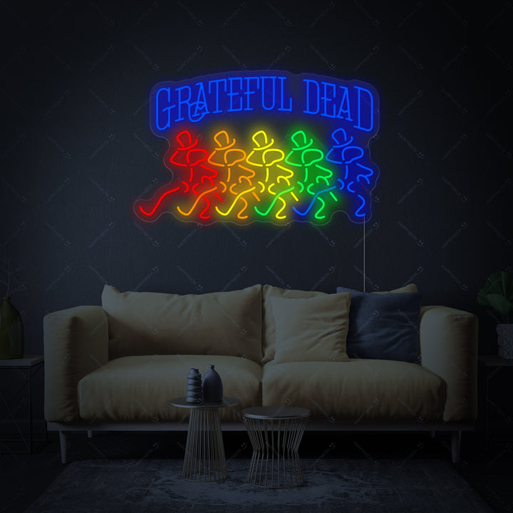 Grateful Dead neon sign with skull logo lit up in blue and red on a rustic brick wall.