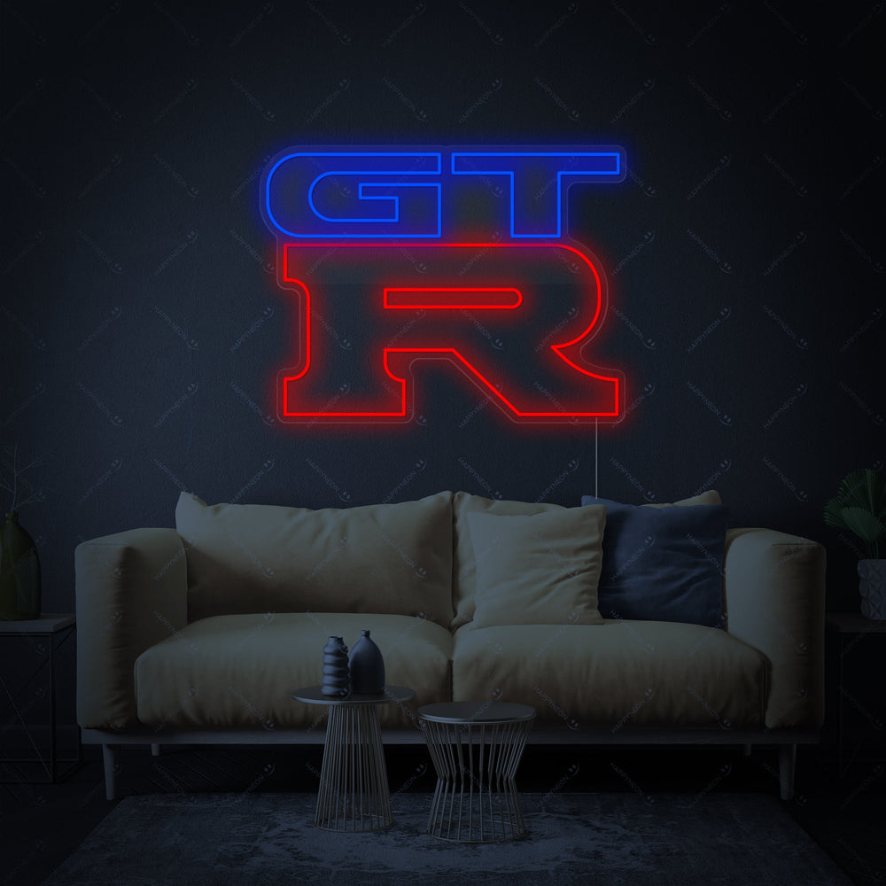 A close-up view of the GTR logo neon sign, showing the detailed glowing red and white neon on a clear acrylic backing.