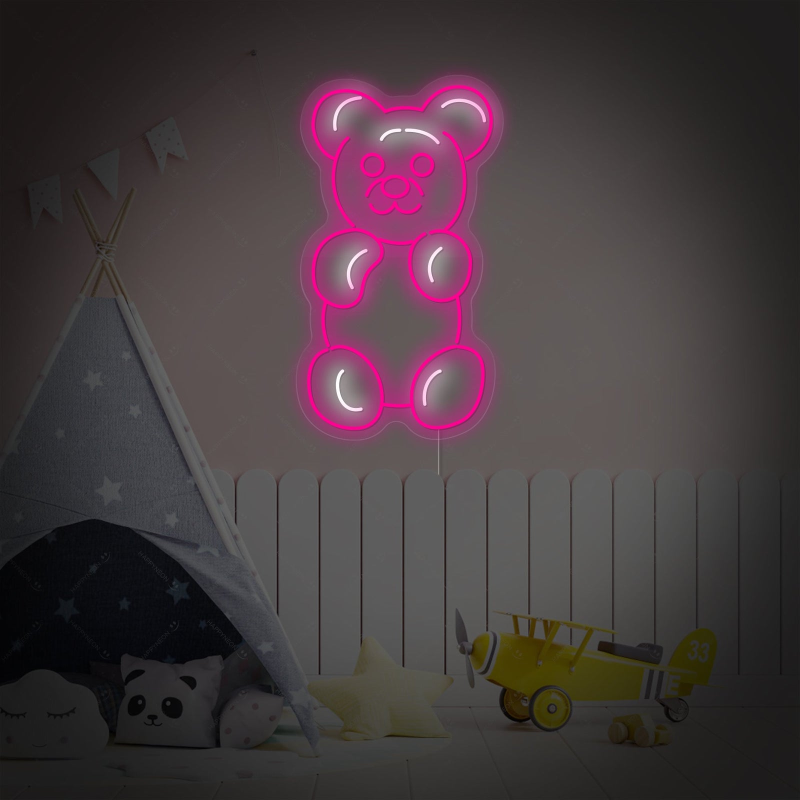 A charming, handcrafted neon sign in the shape of a gummy bear casting a cheerful orange light in a modern, staged children's bedroom setting.