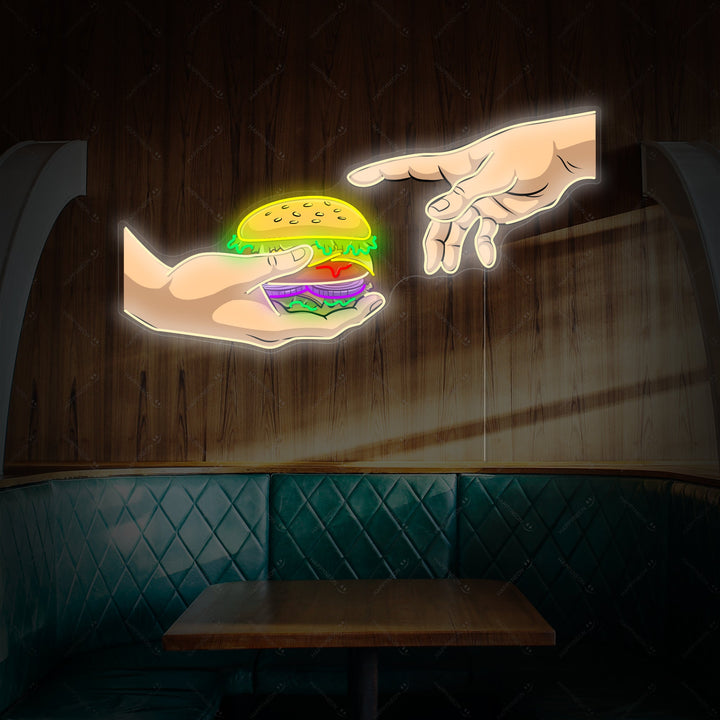 A vibrant 'Hands with Burger' neon sign in red and yellow glows brightly against a dark, textured brick wall above a cozy diner booth, casting a warm light.