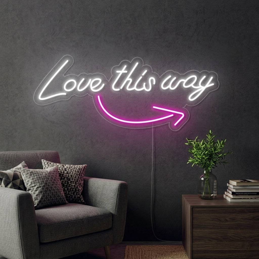 A "Love this Way" neon sign on a clear backing, hanging above a decorative console table in a modern living room setting.