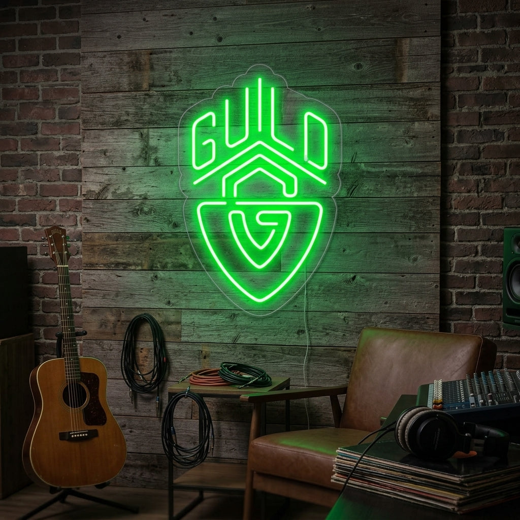 A vibrant Guild Guitars logo neon sign illuminating a dark, cozy music room above an armchair and guitar.