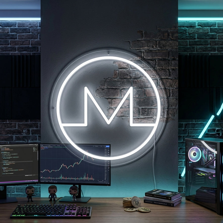 Luminous orange Monero XMR crypto neon sign with a glowing orange and white 'M' symbol and 'MONERO' text glowing on a modern home office wall with a blurred plant and bookshelf in the background.