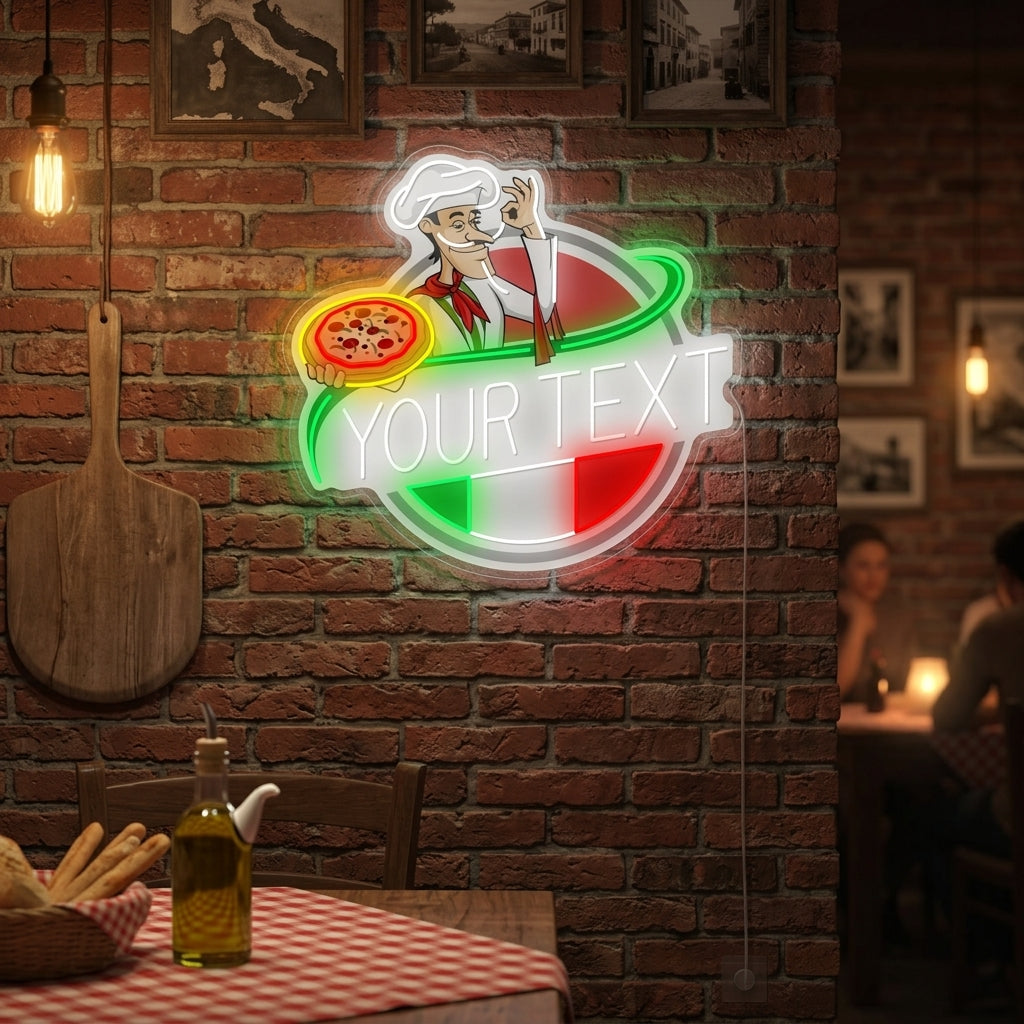 A custom Italian restaurant logo neon sign depicting a chef holds a pizza, glowing brightly above a table setting with food in a dining area.