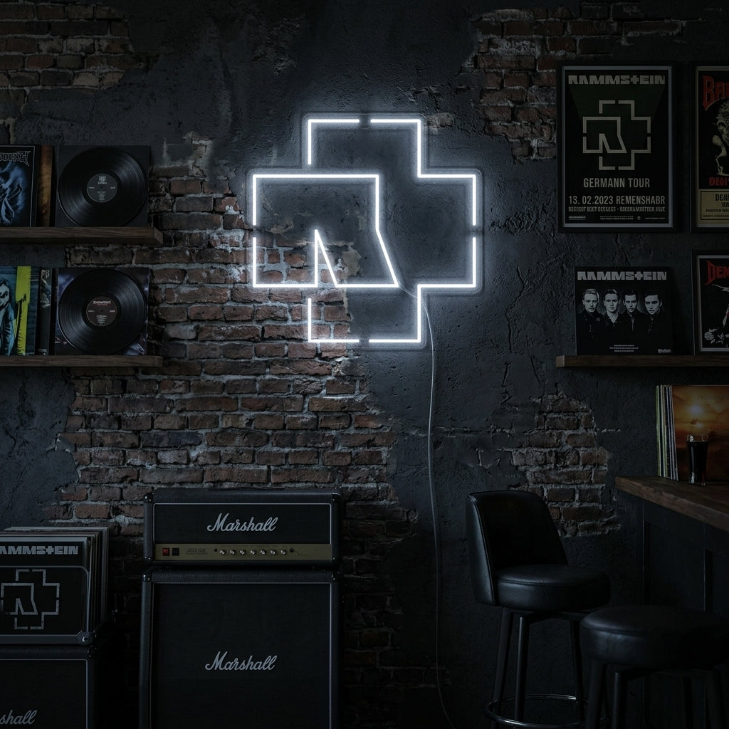 A lifestyle shot showing the illuminated Rammstein logo neon sign hanging on a dark brick wall in a rustic room.