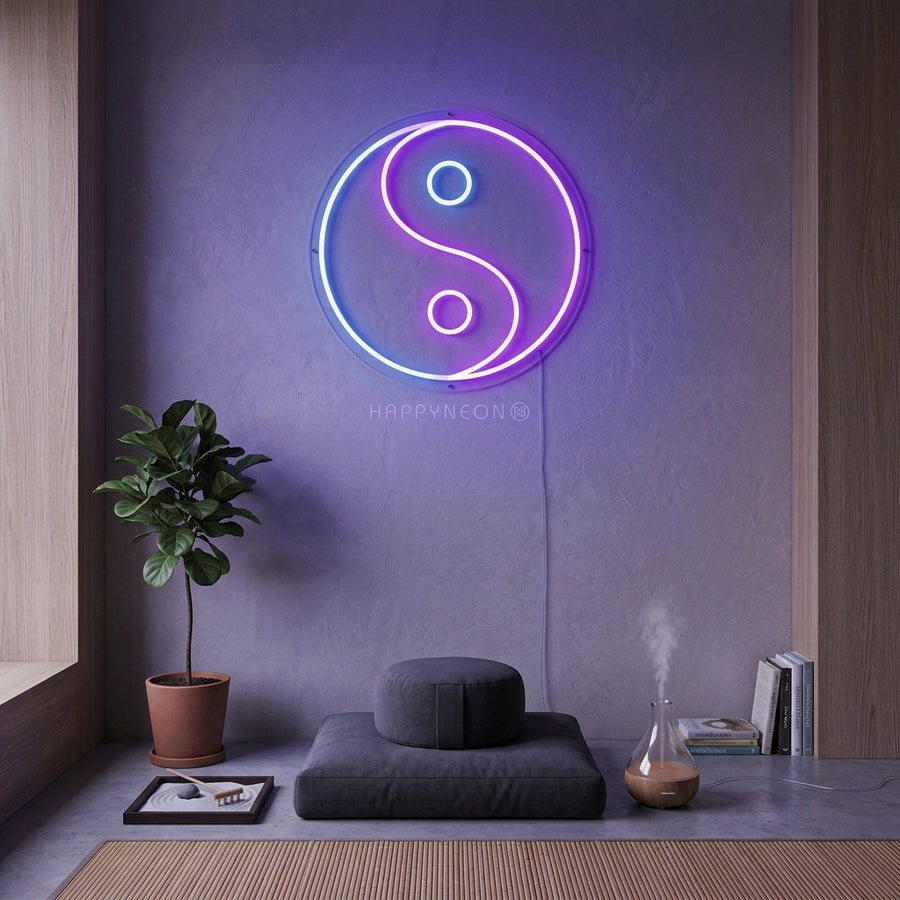 A lifestyle photograph of the illuminated Yin Yang Balance neon sign glowing softly on a textured wall in a contemporary living space.