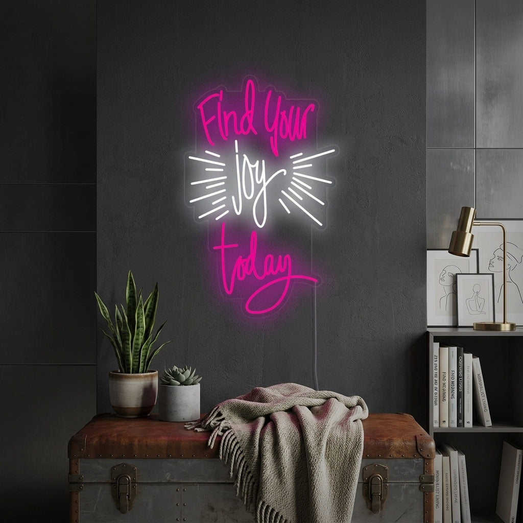 'Find Your Joy Today' white script neon sign on a cozy living room shelf with plants and books.