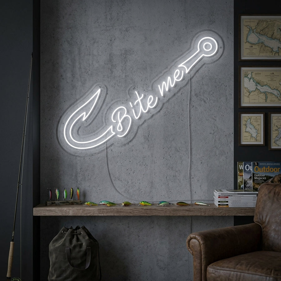 Illuminated 'Fishing Bite Me' neon sign featuring an orange glowing fish and blue text, hanging on a textured wall in a home bar setting.