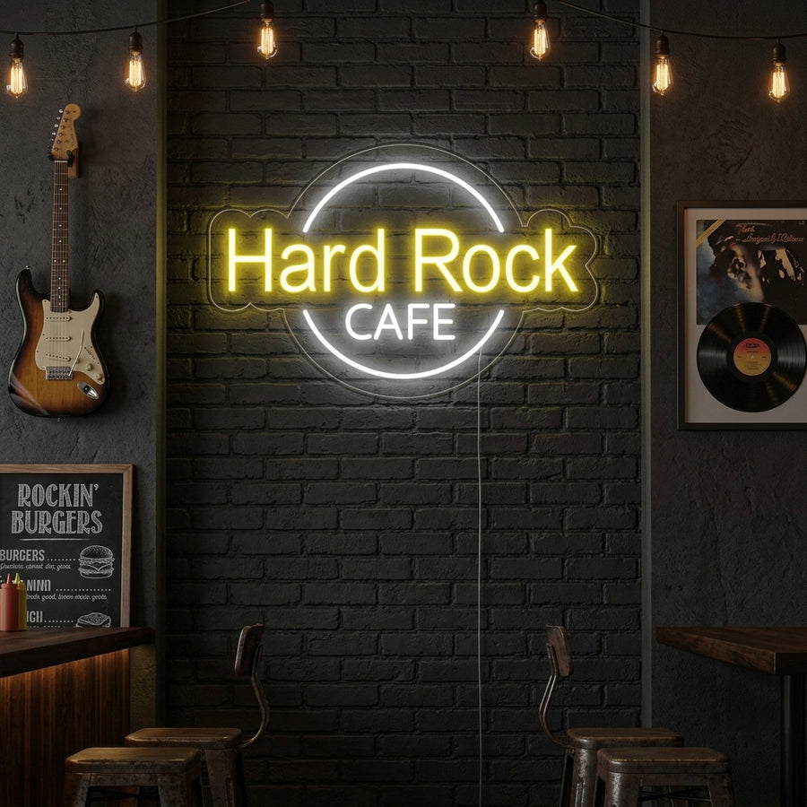 A Hard Rock Cafe neon sign glowing above a bar counter in a modern home lounge setting.