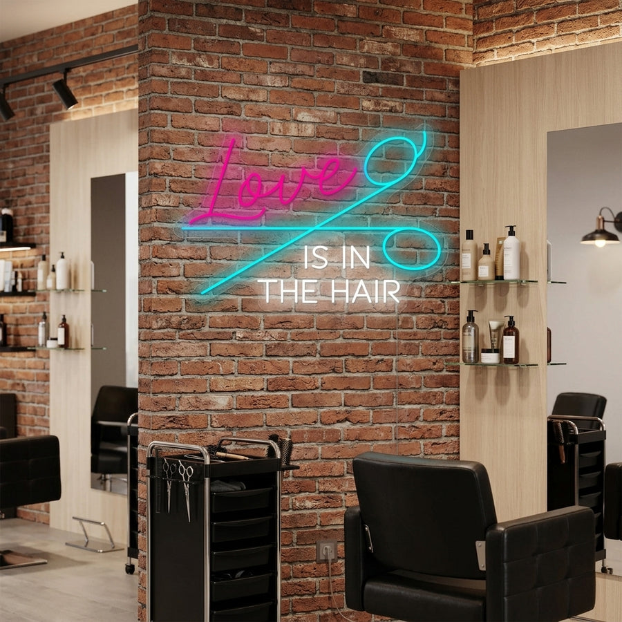 A vibrant 'Love Is In The Hair' neon sign illuminating a modern salon wall, showcasing stylish barber chairs and decor in a chic, realistic lifestyle setting.