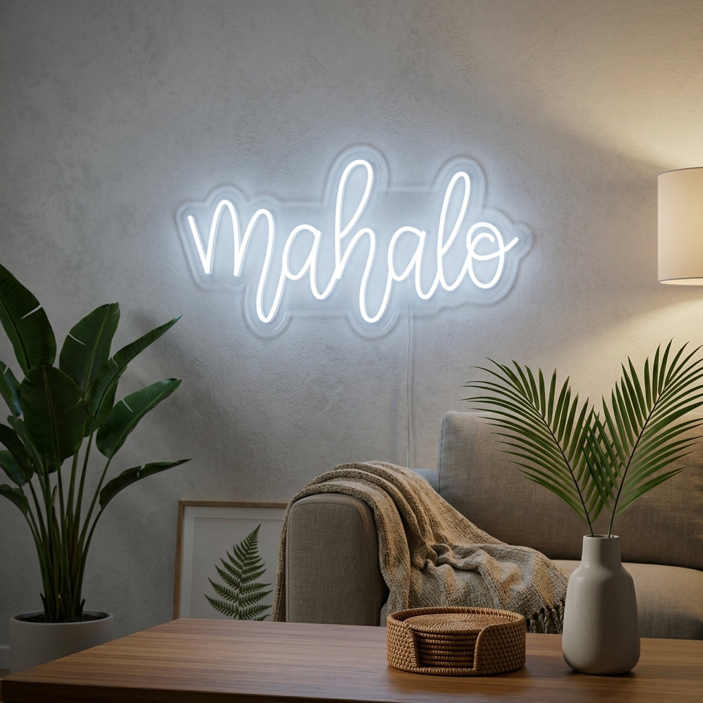 A glowing 'Mahalo' neon sign with Hawaiian thank you text, displayed as wall decor in a modern living room setting.