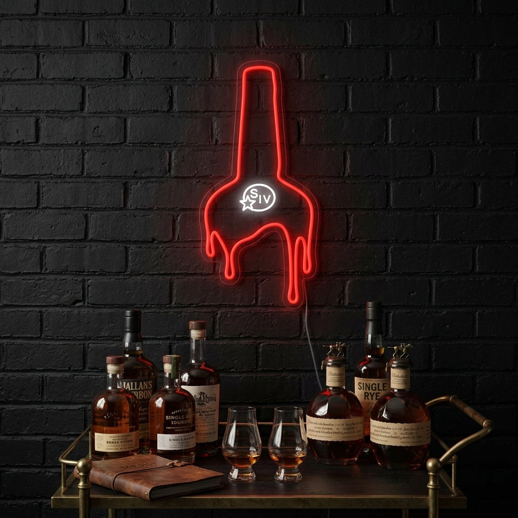 A Maker's Whiskey neon sign illuminating a bar area.