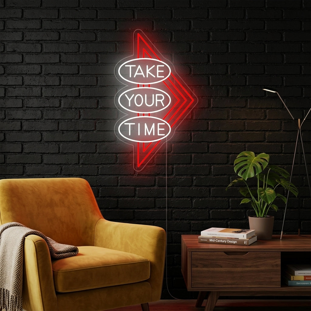 A candid lifestyle photo of the 'Take Your Time' neon sign glowing above a modern desk in a home office.