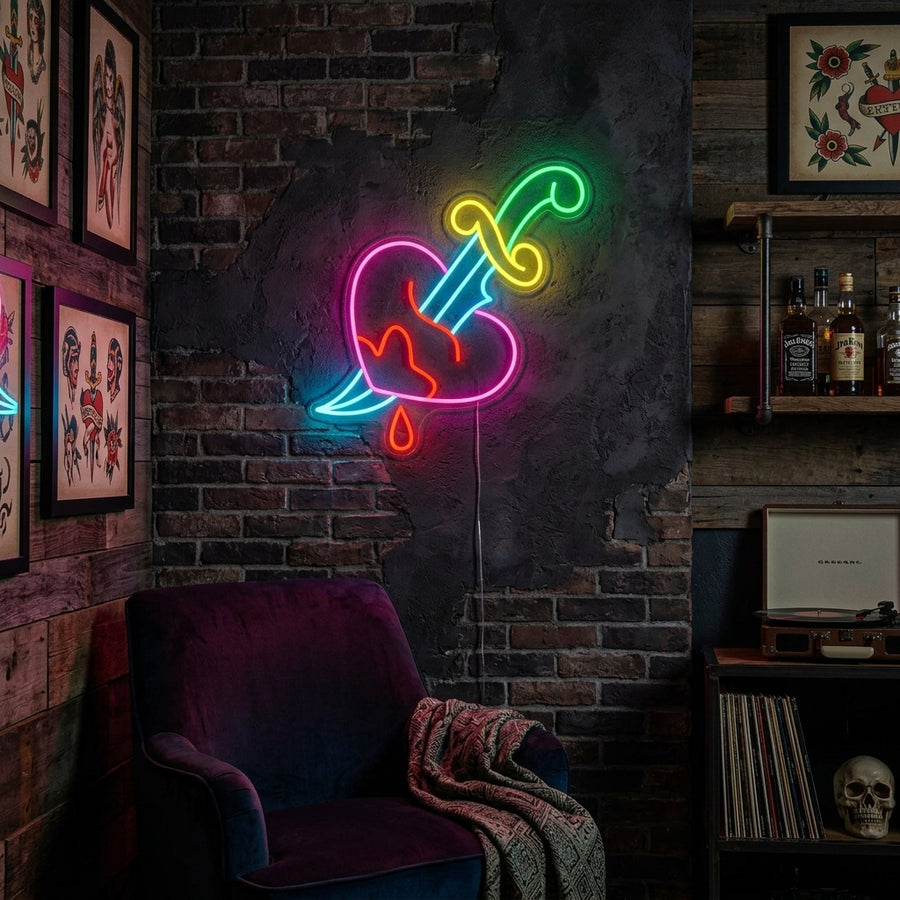 A lifestyle shot of the lit "Knife in Heart Broken Love" neon sign on a textured dark bedroom wall, casting an intense red glow over a made bed and bedside table, creating a dramatic and moody atmosphere.