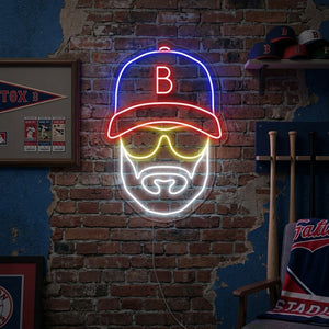Baseball player with hat icon neon sign illuminated on a brick wall in a living room.