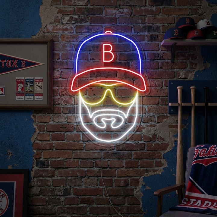 Baseball player with hat icon neon sign illuminated on a brick wall in a living room.