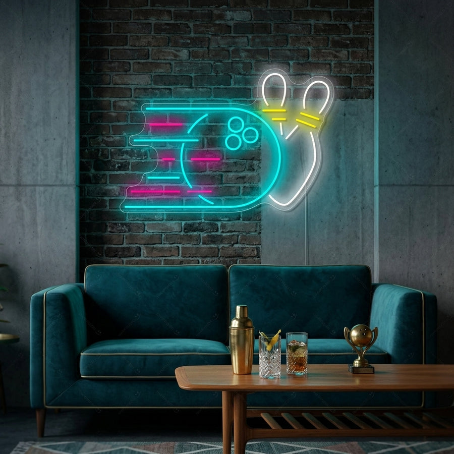 A glowing Bowling Ball neon sign, featuring a black ball knocking over two pins, mounted on a rustic wood plank wall in a cozy lounge area.