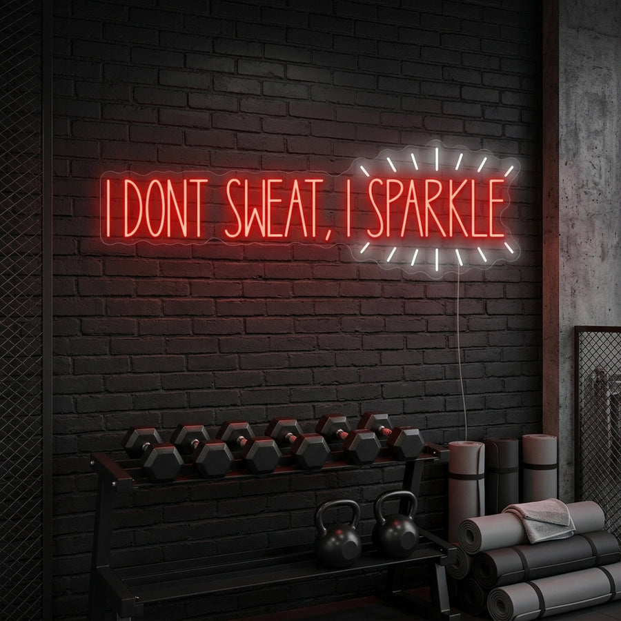 A glowing 'I Don'T Sweat, I Sparkle' neon sign mounted on a dark textured wall above a cozy home gym setup.