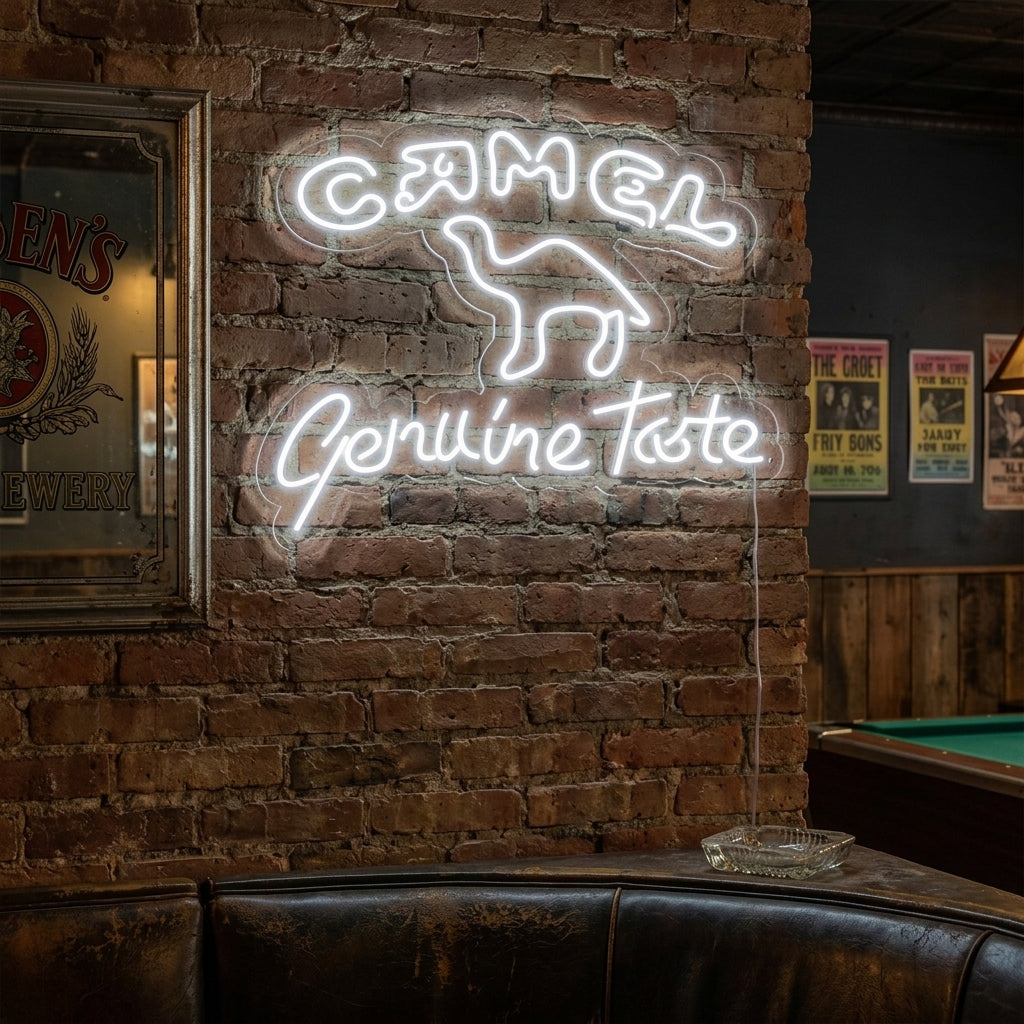 A lifestyle photo showing the glowing orange camel logo neon sign mounted on a brick wall above a couch in a cozy lounge setting.