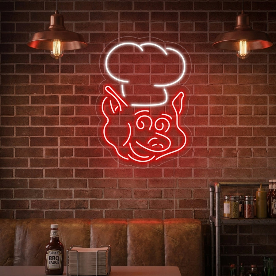 Pig Chef neon sign hanging in a modern rustic setting near industrial furniture and a bar area.