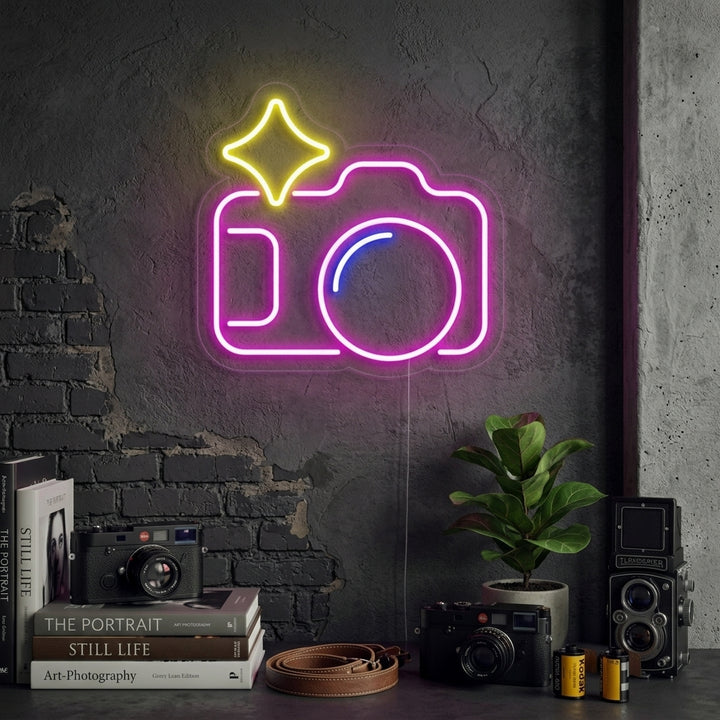A vibrant neon sign depicting a vintage camera outline glows on a neutral wall in a stylish room.