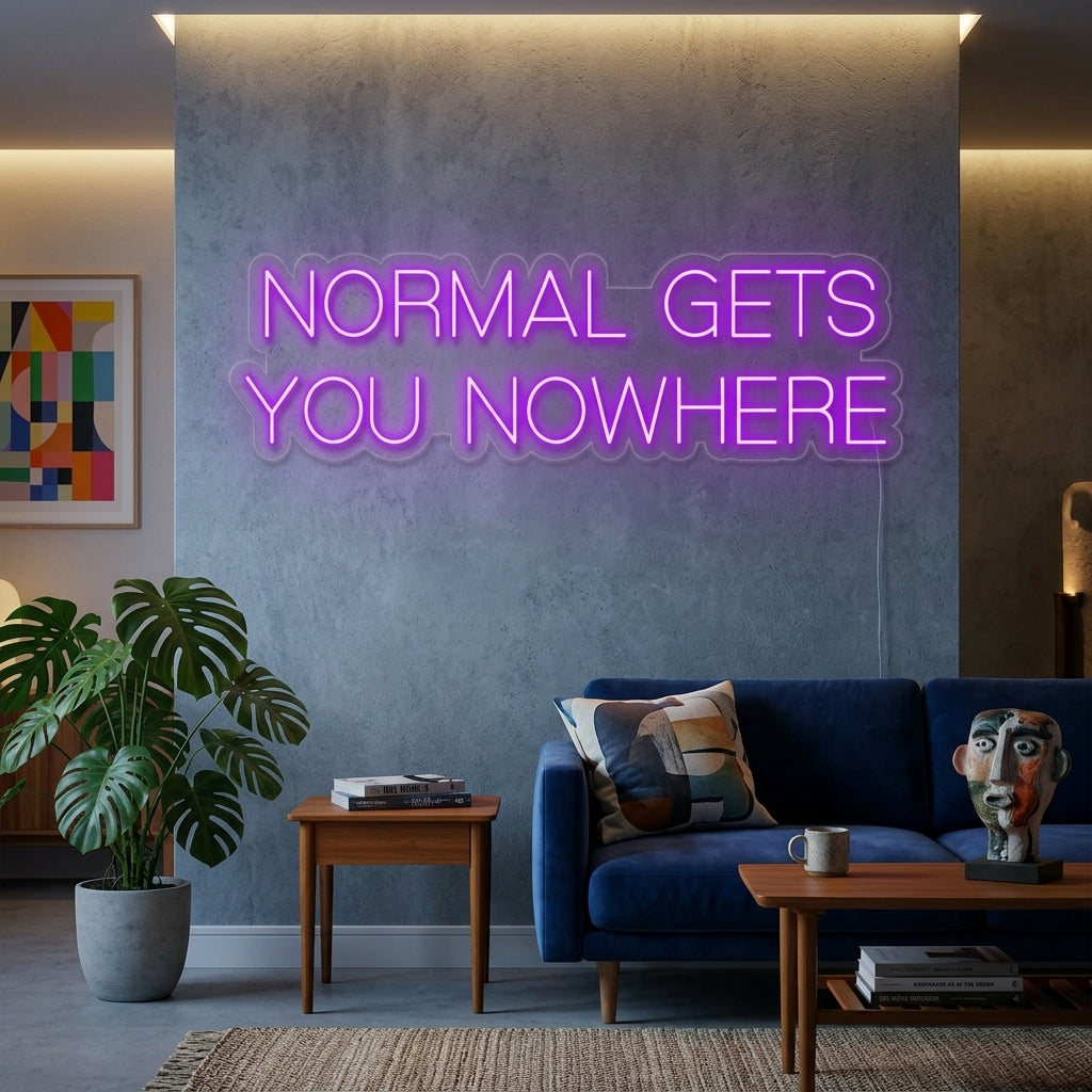 A glowing blue 'Normal Gets You Nowhere' script neon sign illuminates a cozy home office, mounted above a wooden desk with plants, books, and a laptop.