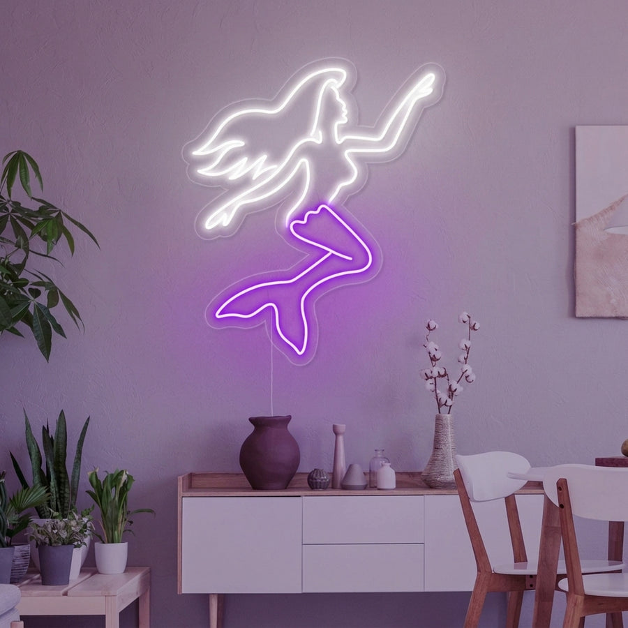 An artistic Mermaid Sexy Girl neon sign glowing pink on a textured wall, shown in a lifestyle setting.