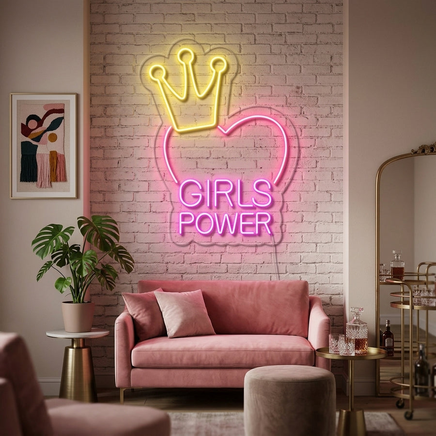 Vibrant pink glow from a 'Girls Power' script neon sign mounted on a stylishly textured brick wall in a cozy room.