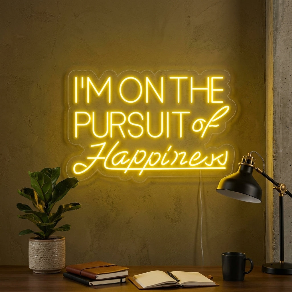 A stylish 'Pursuit of Happiness' neon sign glowing on a bedroom wall above a cozy armchair.