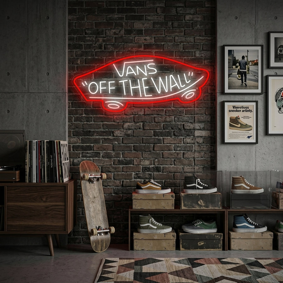 A close-up photograph of a Vans Off The Wall neon sign glowing on a garage wall, mounted above a parked motorcycle.