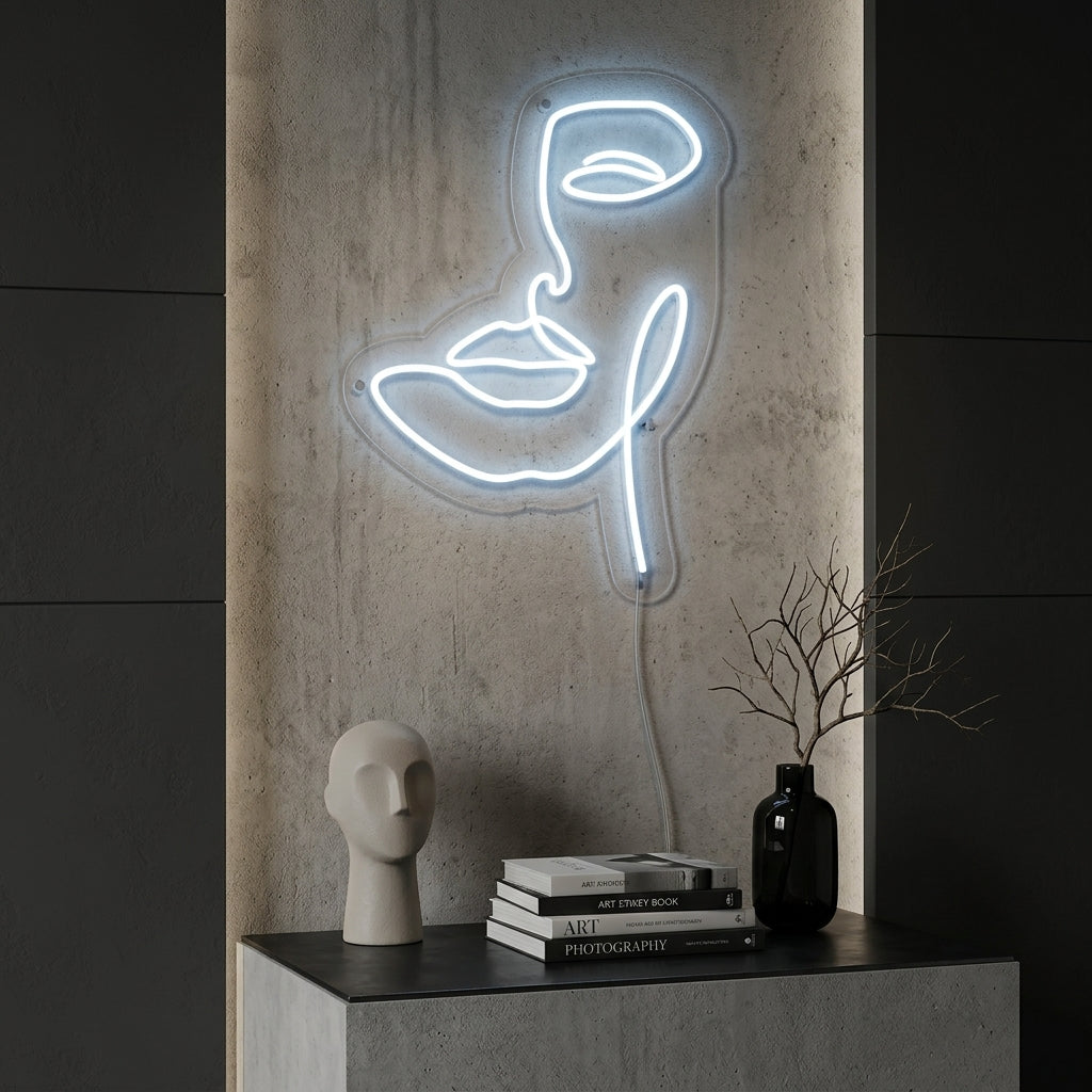 Abstract neon sign of a woman's face silhouette in a modern bedroom