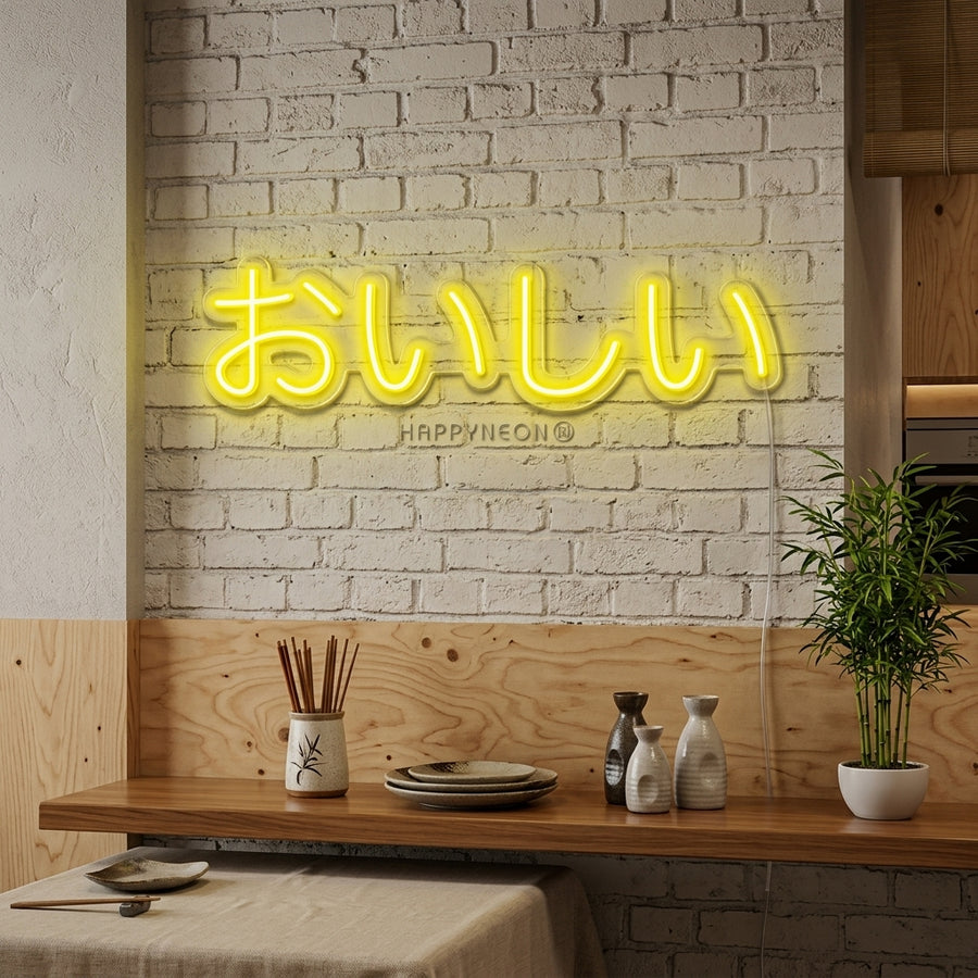 A glowing blue 'Oishi Delicious Japanese' neon sign with red Japanese kanji accents, displayed on a textured wall.