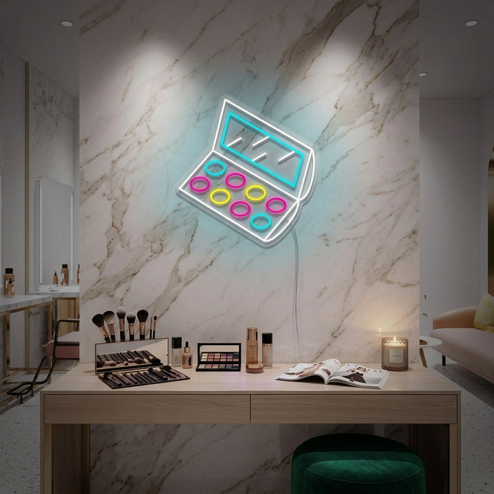 Glow from an 'Eyeshadow Palette' neon sign illuminating a stylish vanity and makeup station.