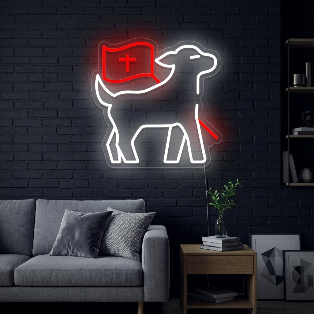 A lifestyle photograph showing the glowing white 'Lamb with Cross' neon sign mounted on a textured brick wall in a cozy room setting.