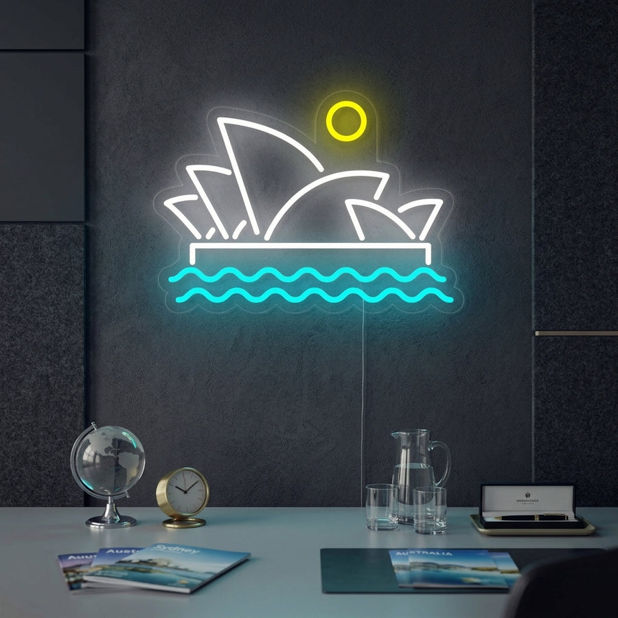 A vibrant neon sign depicting the Sydney Opera House glowing on a wall in a stylish living room setting.