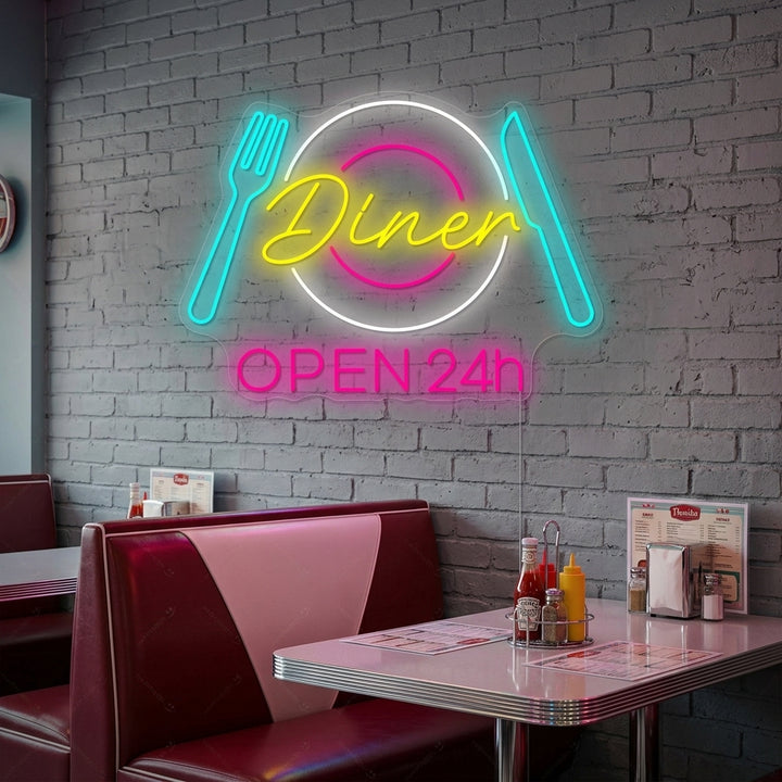 Warmly lit interior shot of a classic American diner booth at night, featuring a luminous pink and blue 'Dinner Open 24h' neon sign on the wall, creating an inviting glow.