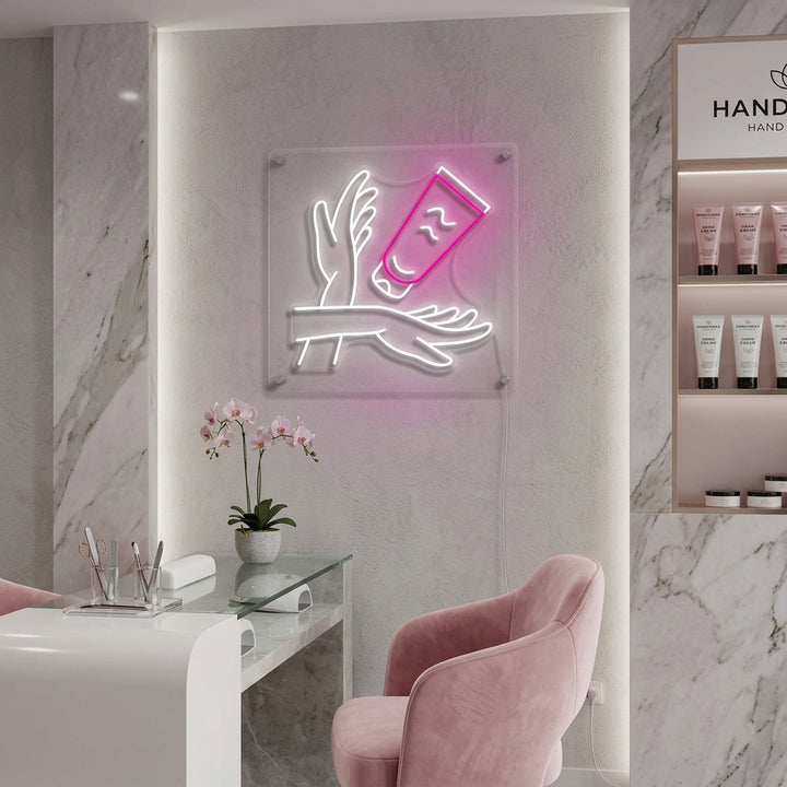 Close-up photograph of a glowing blue "Hand Care" neon sign with a stylized hand icon, mounted on a rustic bathroom wall above a concrete sink.