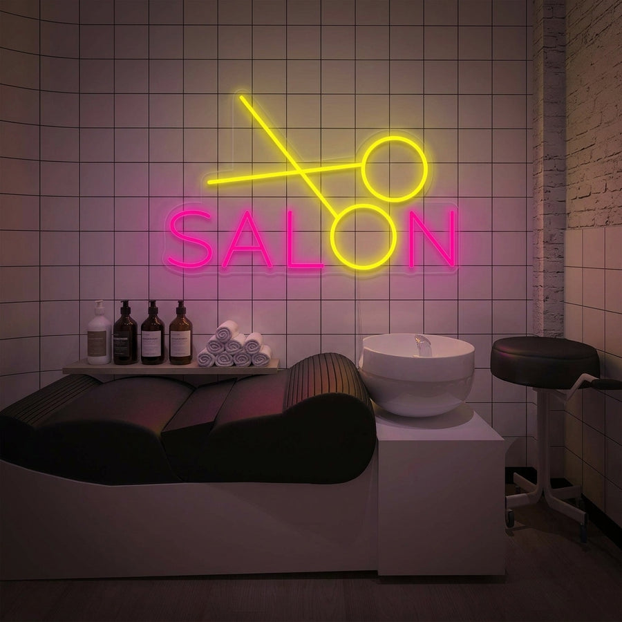 A vibrant 'Hair Salon' neon sign glowing in a stylish, modern salon setting above a mirror and styling chair.