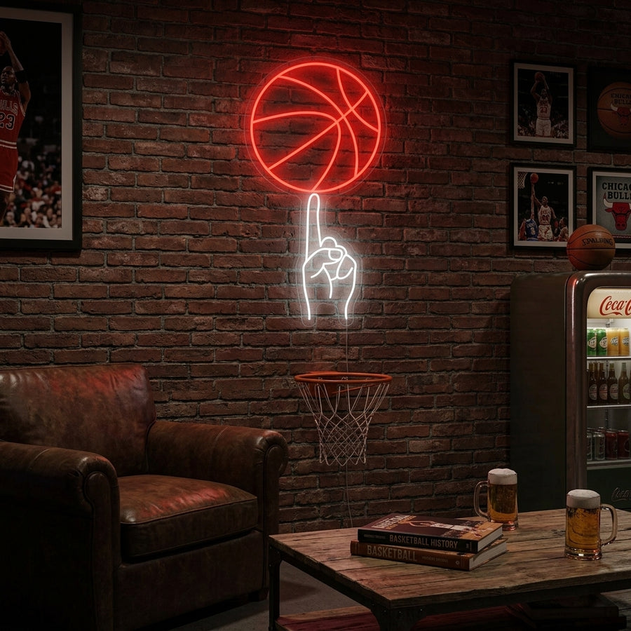 Basketball neon sign glowing orange and white on a brick wall above sports memorabilia and modern furniture in a man cave setting.