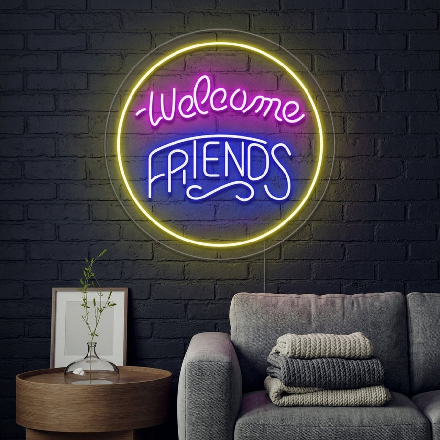 A lifestyle photo of the 'Welcome Friends' neon sign glowing warmly above a modern sofa in a cozy, inviting living room.