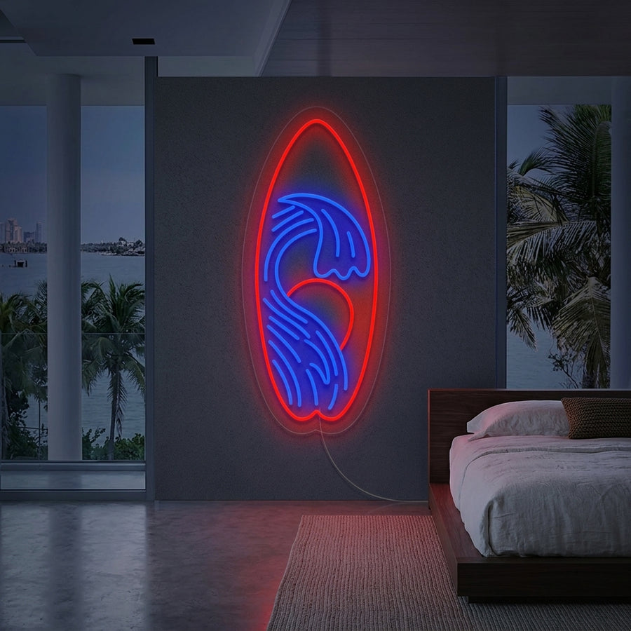 A vibrant 'Surfboard Surf' neon sign glowing on a textured white wall above a wooden console table with coastal decor.